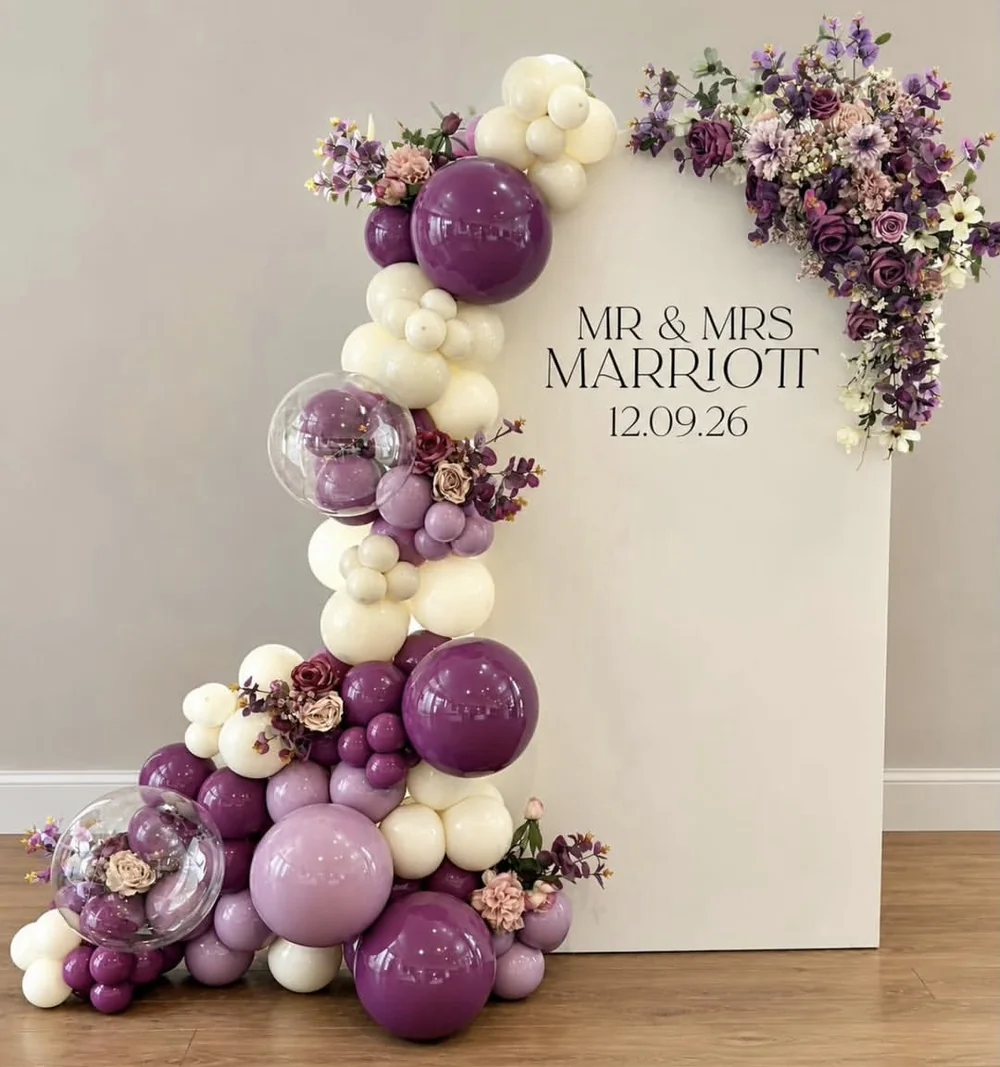 Complete plum, lilac and ivory balloon backdrop with a floral installation and personalised panel