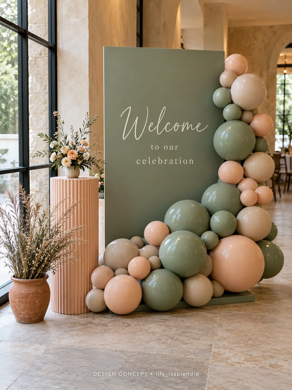 Sage, blush and ivory balloons framing a welcome sign at a celebration